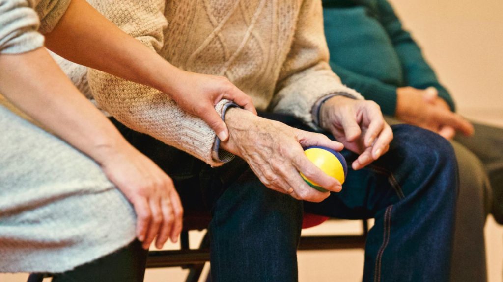 Älterer Mann hält Ball in der Hand
