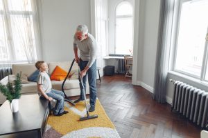 Vater und Sohn saugen Wohnzimmer